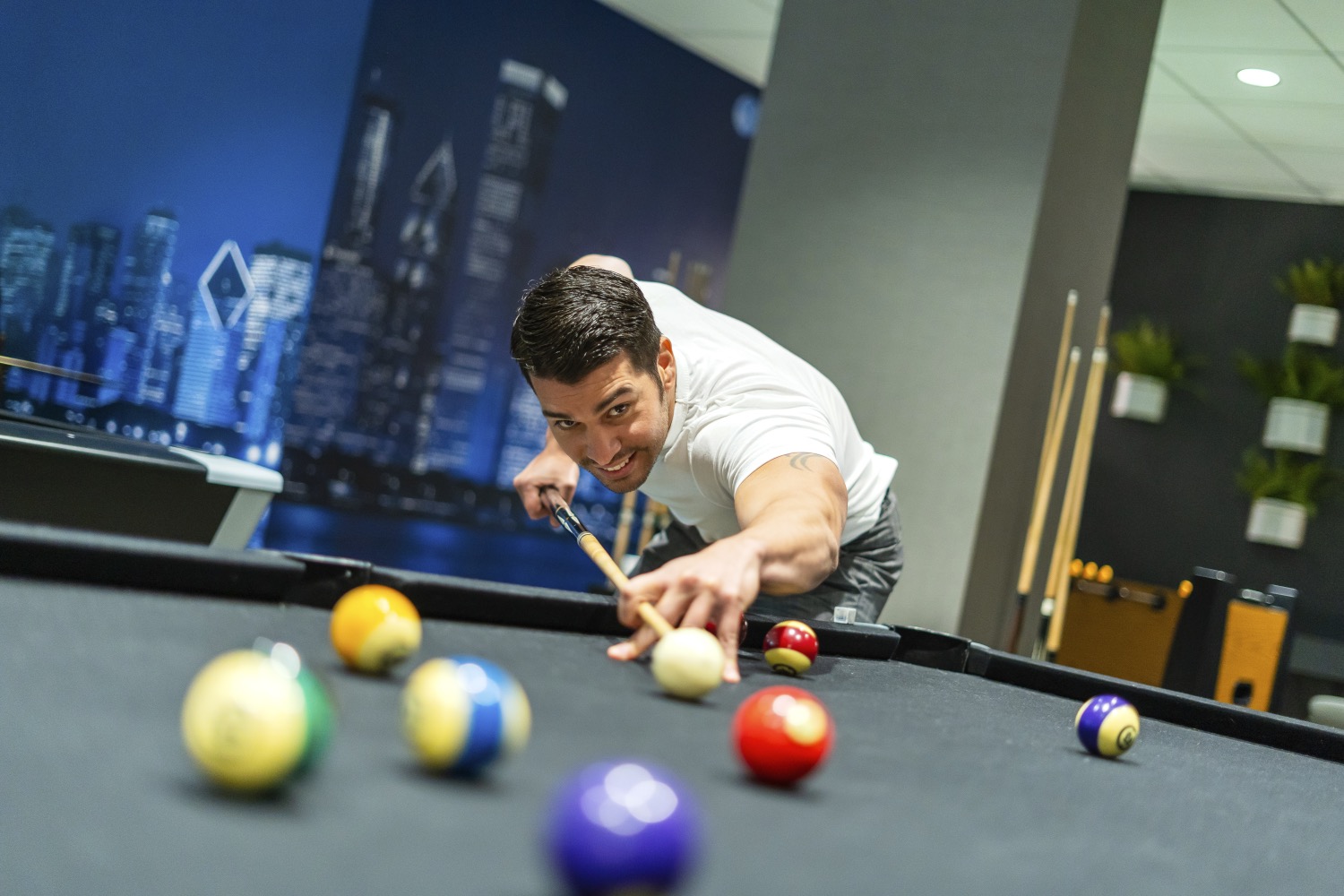 man playing billiards at arrive mission valley