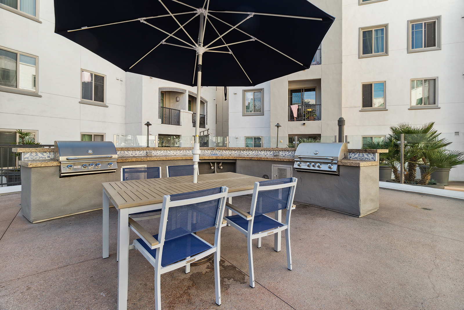 luxury san diego apartment poolside grills and picnic table